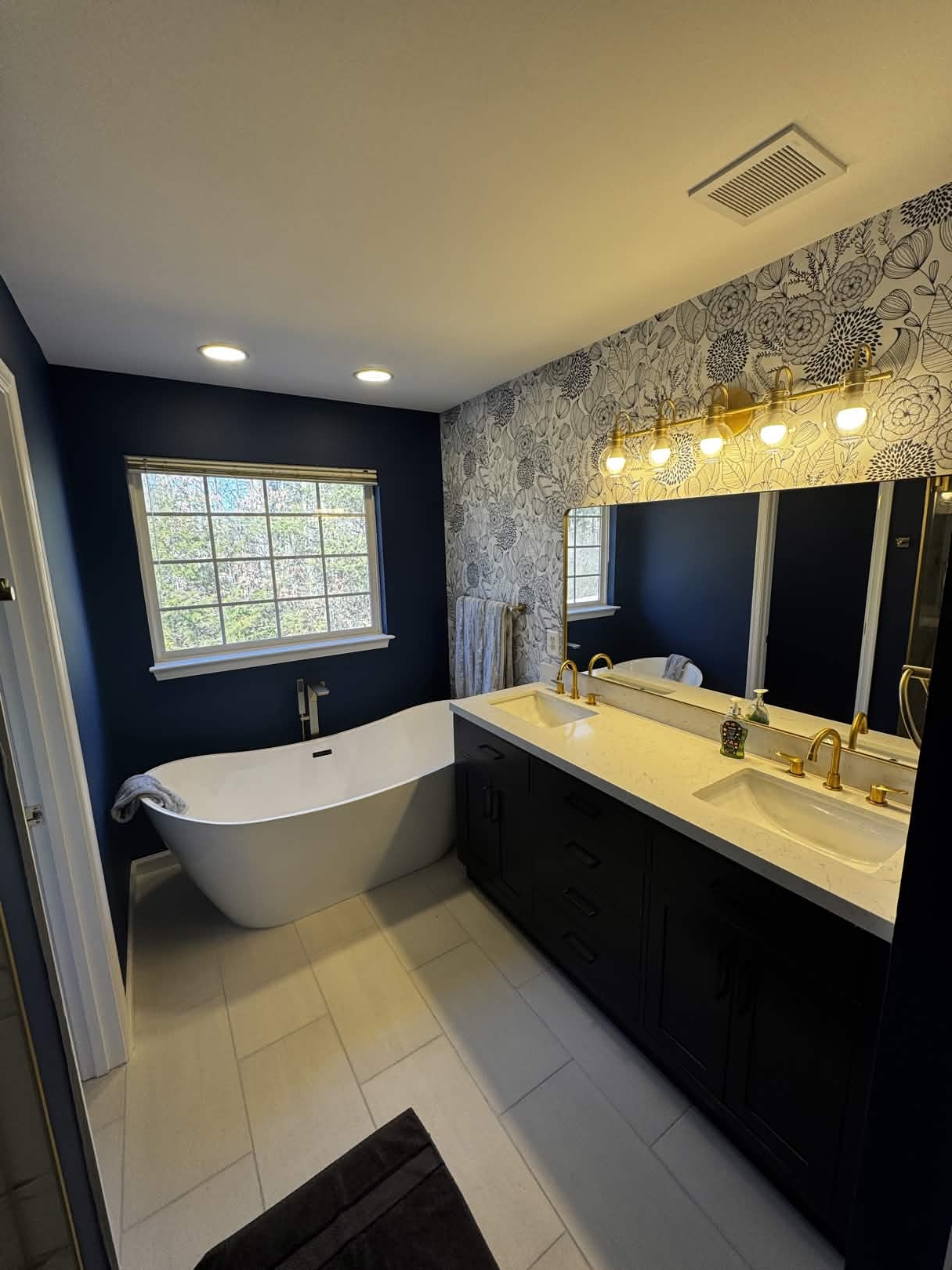 Navy master bath with freestanding soaking tub
