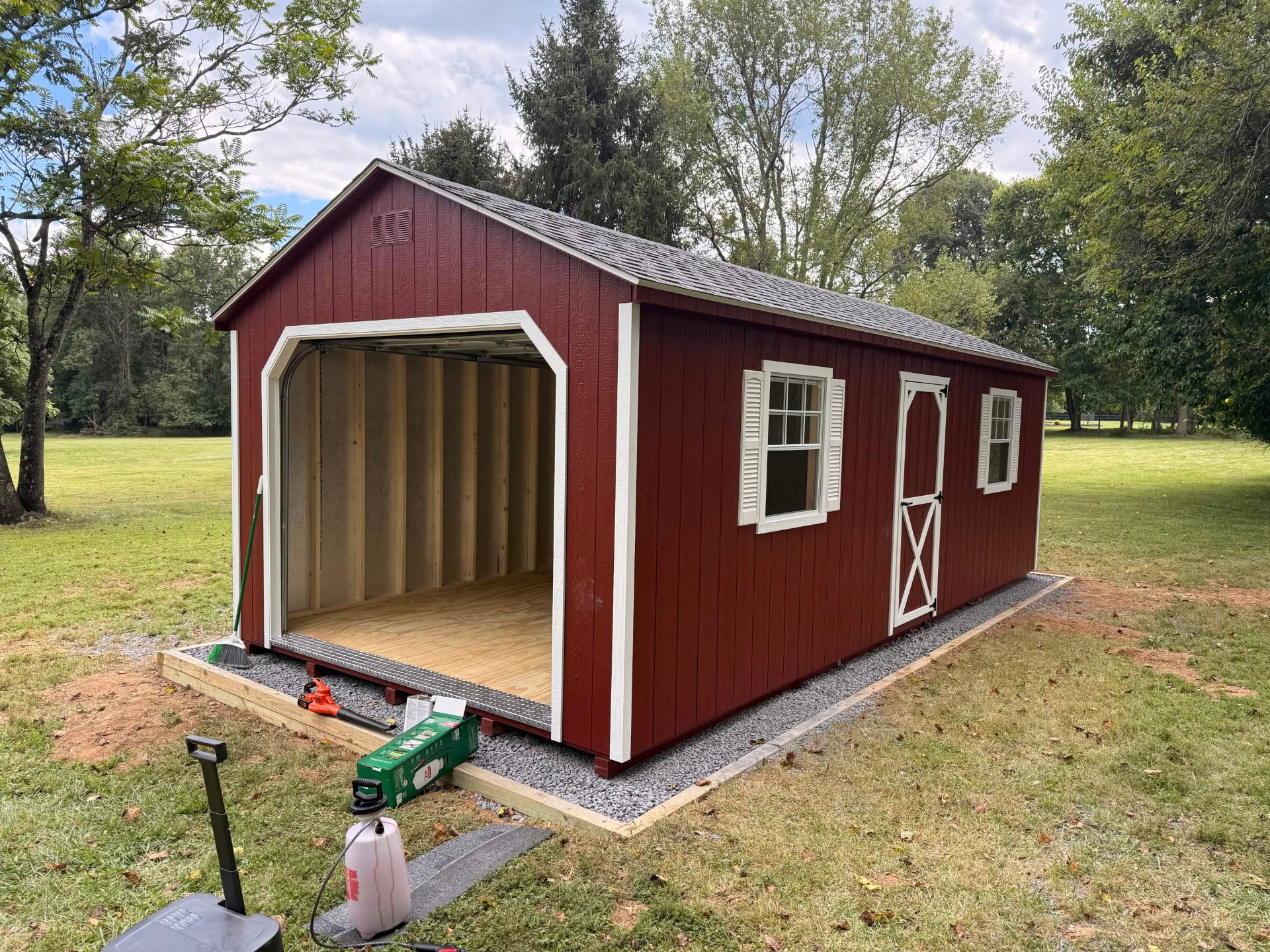 Custom 12×24 garage-door shed on gravel pad